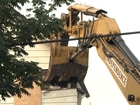 Excavator takes first chomp out of house of horrors