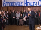 Obama defends health care law